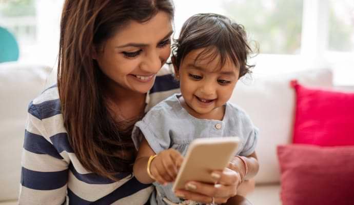 mother and baby looking at a phone